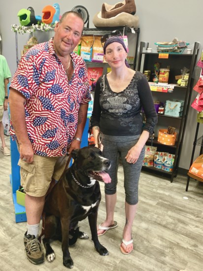 Bruno, a proud Black Mastiff, poses with owners Richard & Heather King.