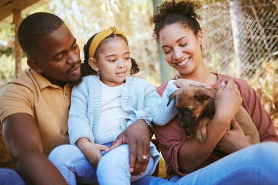 A family with a dog. 