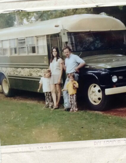 Chad Otis is in the yellow shirt--picture of his family and their bus