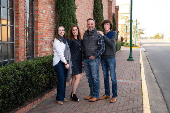 Downtown textures and architecture give family portraits a polished, distinctly local feel.