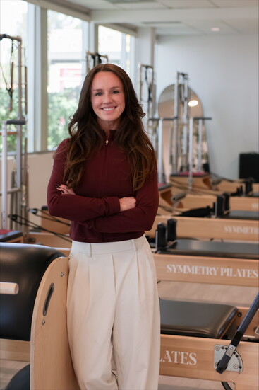 Sheridan standing in front of the reformers in her studio