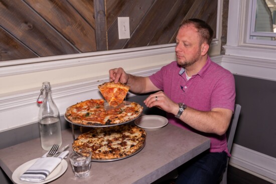 Richard samples the Enzo (top) and maple bacon (bottom) at Lombardi Pizza Co.