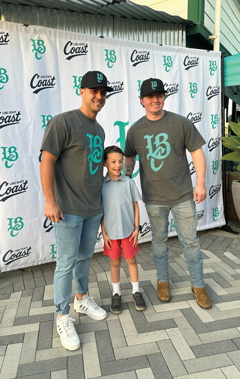 Jacob Jablonski (left) and Brett Wozniak (right) take a photo with a fan. 