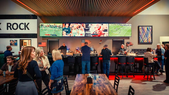 Patrons enjoy a drink at the bar