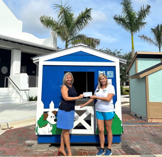 Christine Masney (L), Wellen Park VP of Marketing presents Habitat for Humanity South Sarasota County’s CEO, Christina McCauley with Wellen’s $15,000 donation.