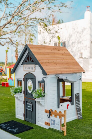 Sam Rodgers Homes’s playhouse features "Sam's Coffee Cafe," complete with a menu, kitchen, and seating area.