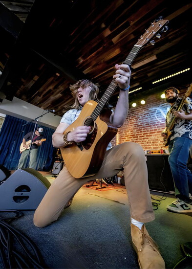 Greg Gilman lights up the stage on guitar during the Battle of the Bands. Photo Credit: Fabien Castro