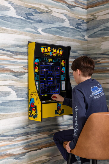 The Quisenberry’s son tries his luck on the Pac-Man video game, nestled in the corner of their playroom