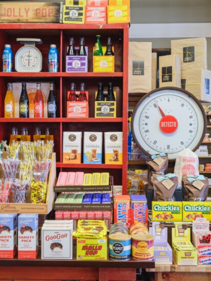 Sodas and candy are attractively displayed at a counter in PLENTY Mercantile.
