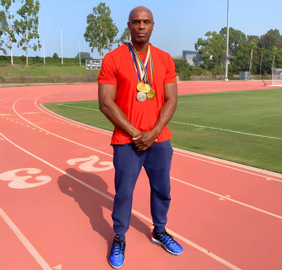 Wearing his gold and silver medals, a snapshot of a career that made history on the track and continues to inspire.