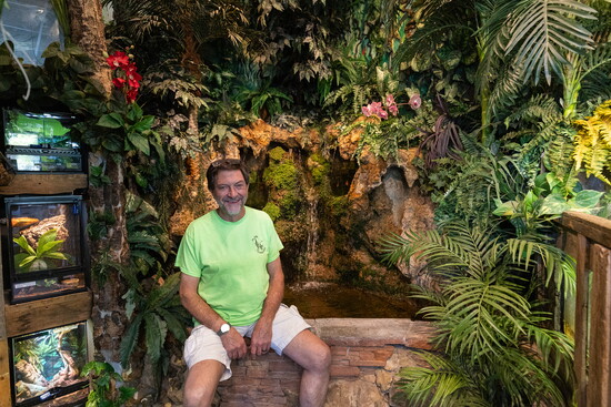 Bruce Longwell, owner of The Fish Connection, surrounded by the lush aquatic plants