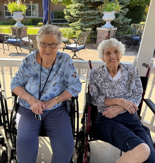 Caryl, pictured on the left, can often be found in her favorite spot: on a porch!