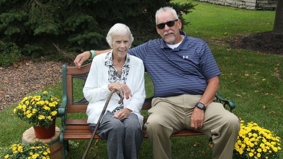 Norma and her son pictured outside on the lovely grounds of The Cottages.
