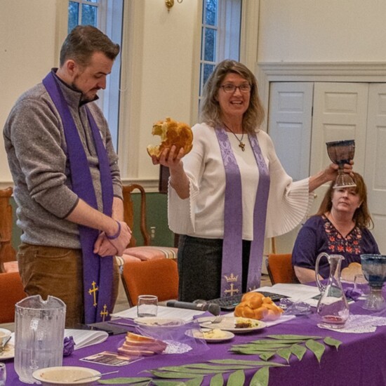 Pastors Chris McAuliffe and Emily Berman D’Andrea serving communion on Maundy Thursday.
