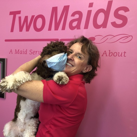 Marnie Hamel, co-owner of Two Maids & A Mop of Rockville, with her coronavirus-safe Bernedoodle named Gatsby.