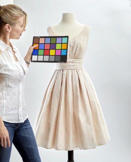Bespoke Southerly founder Sheri Turnbow holds a color card near one of her company’s custom dresses.