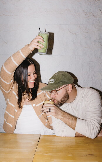Chris and Ali McColl, co-founders of Our Spot Coffee, share a moment over drinks.
