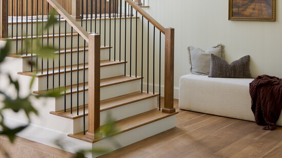 Huge picture windows and a beautiful chandelier help elevate this staircase into a work of art.