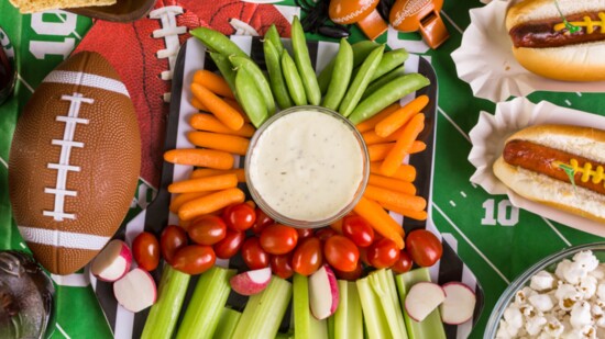 West tailgaters gather around Sliders from Dave’s Quality Meats, Raymond’s Pizza, Wings and Rings appetizers and Delicious Designs Cookies.