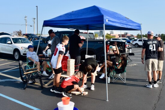 Fans of all ages gather to play games, eat and cheer on the Thunderhawks football team before each home game.