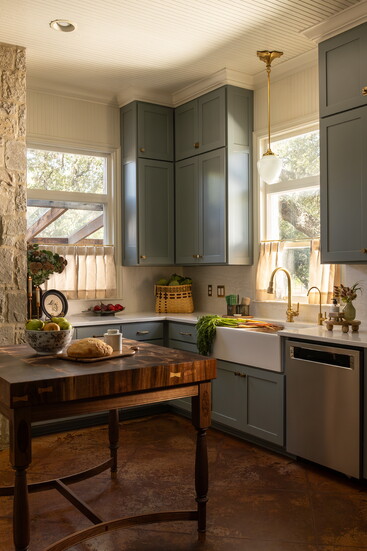 Cafe curtains with a classic pinch pleat and ticking fabric let in all of the gorgeous natural light.