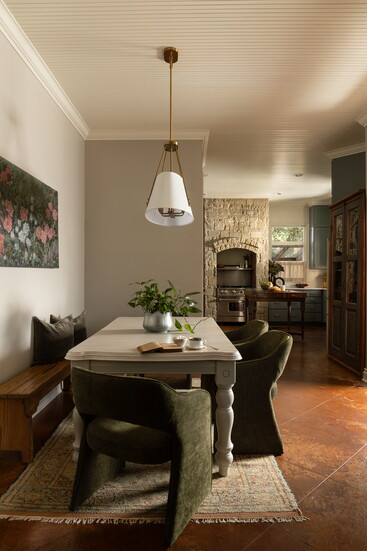 The whitewashed top of the breakfast table balanced the moss-green chairs, while the natural wool rug complemented the commissioned art perfectly.