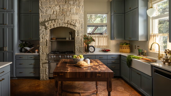 This custom walnut island is the perfect prep space, with an arched base that makes room for extra seating.