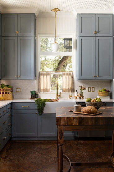 The custom milk glass and brass light was the perfect addition, and the leaf base tied in the natural elements throughout the kitchen.