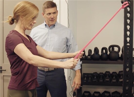 Dr. Matt working with a member in the onsite gym