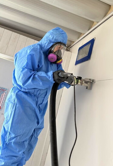 A Coastal Beach Cities Restoration expert works to mitigate water damage.