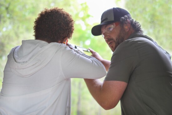 Writer, Pam Reid gets expert instruction from Director of Sporting Clays, Cody Matson