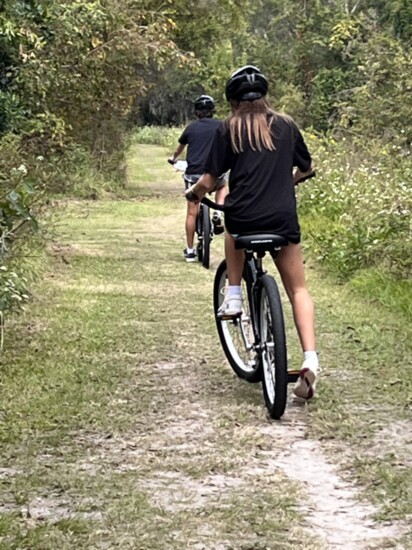 Biking along Egans Creek Greenway