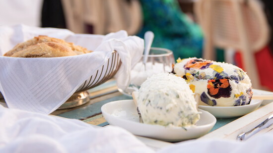 Rustic sourdough with chive butter, handcrafted by Chef Ramsay, sets the stage for an unforgettable garden dinner party under the lights. Photo by Candice Wong.