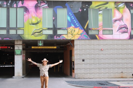 Founder Raasin McIntosh in front of the San Marcos Street Mural. Image by Julie Royce