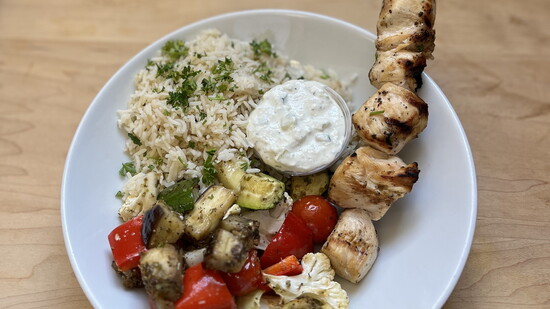 Chicken souvlaki skewers and tzatziki with lemon rice pilaf and roasted Mediterranean veggies is one of Radiant Health Kitchen's most requested meals.