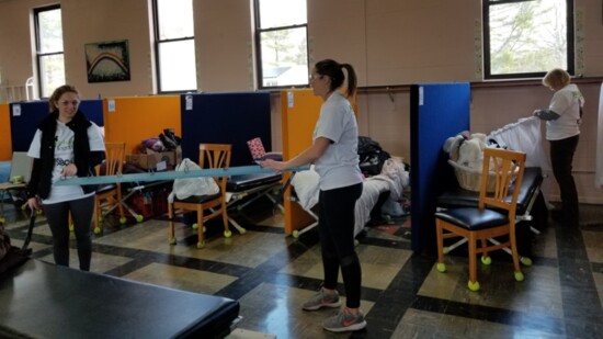 Volunteers setting up curtains at Rainbow Shelter