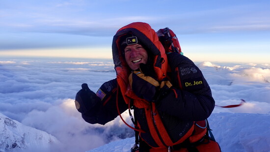 Jon on the top of Mt. Everest. Reaching the summit is more than a climb, it's a testament to perseverance, grit, and the pursuit of extraordinary goals.