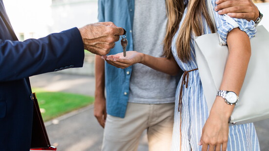 Couple receiving the keys to a home. 