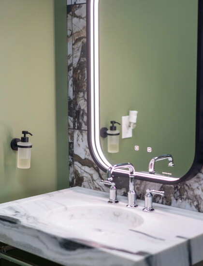 Classic finishes with sleek materials can make a modern bathroom space. 