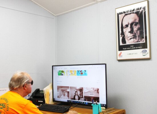 Al Yougel of Keep Peachtree City Beautiful works under the watchful eye of 70's environmental icon Iron Eyes Cody.  