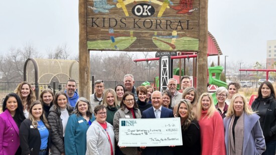 Armando Rosell from Rosell & Love, PLLC, and The Toby Keith Foundation present 10 charities with $1,000 checks to celebrate their 10-year anniversary.