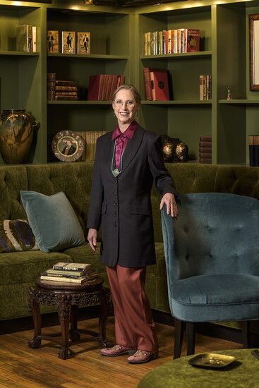Nancy Chase in The Mercantile Library, surrounded by restored furniture & decorative arts from its collection. Styling by Diane B. Amon.