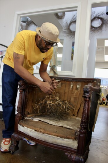 Alim unties the springs in an antique chair padded with horsehair. 
