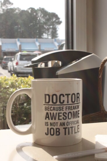 Noble Harris's coffee cup also acknoledges his status as a doctor. 