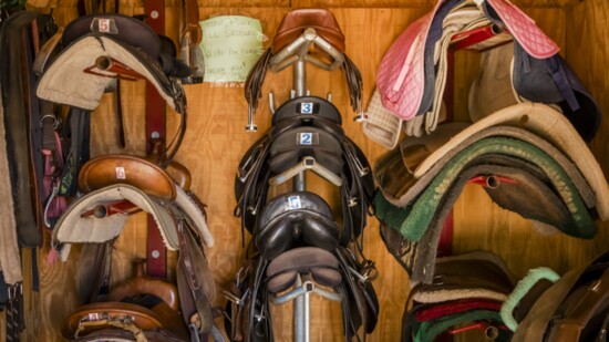 Well loved English and Western saddles in the tackroom at the GAIT barn at Green Acres Ranch in Temecula.