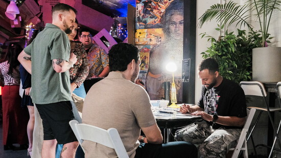 Samuel giving watercolor lessons at a corporate event. Photo by Kameal Mock.