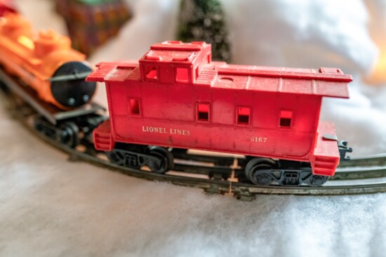 A classic Lionel "O" gauge caboose in a winter tableau.