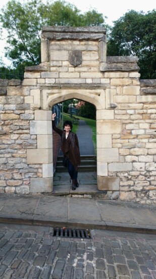 Rilla pauses to have her photo taken during a visit to Lincoln, Lincolnshire, UK, while she was conducting research for her Tudor novel on Anne Askew.