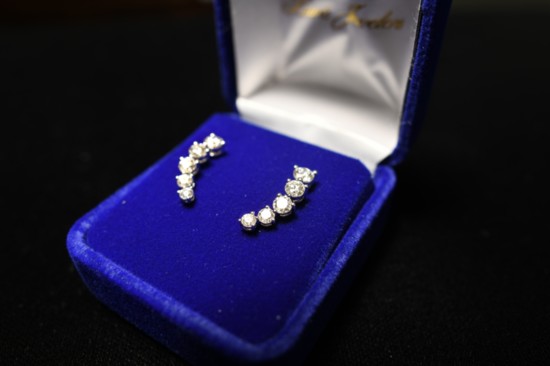 18 karat white gold and diamond ear climber earrings set with 10 round brilliant-cut diamonds; set with three Forevermark Diamonds each. $6,870