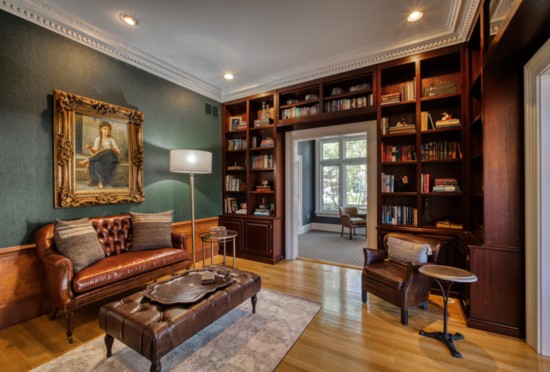 Who wouldn't want to curl up with a book in this elegant room with a leather sofa and chair? 